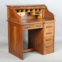 A George V oak tambour roll-top single pedestal desk of small proportions, height 110cm, width 92cm,
