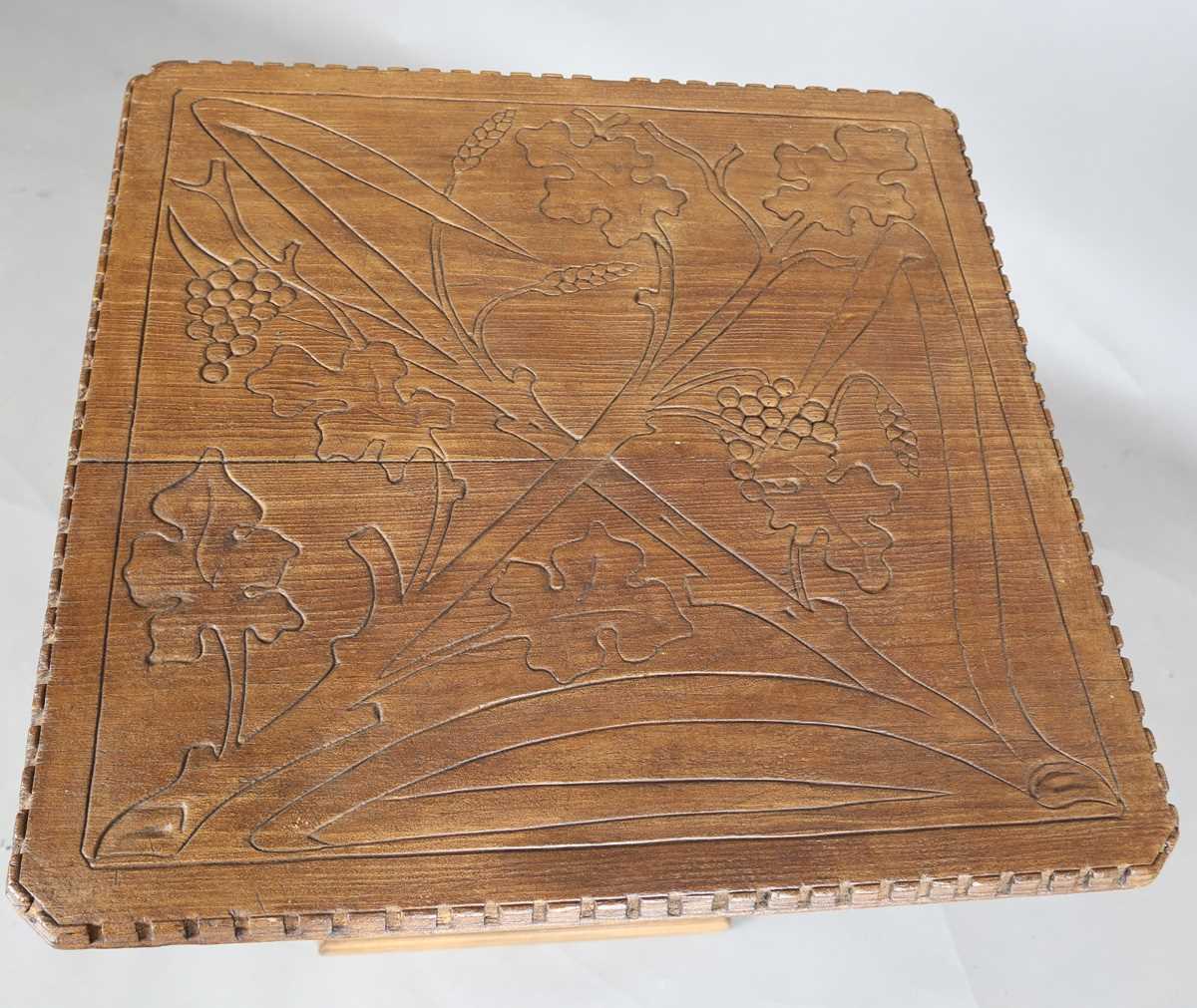 A 20th century Arts and Crafts style carved softwood centre table, the top decorated with wheat - Image 2 of 10