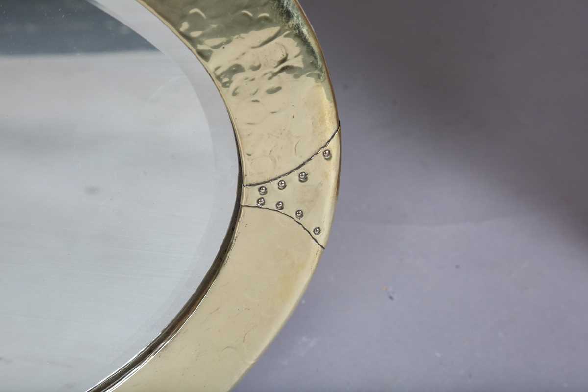 An early 20th century Arts and Crafts brass oval wall mirror with riveted panels and raised - Image 4 of 7
