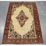 A Kerman rug, Central Persia, mid-20th century, the ivory field with a floral medallion, within a