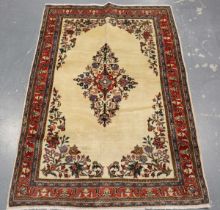 A Kerman rug, Central Persia, mid-20th century, the ivory field with a floral medallion, within a
