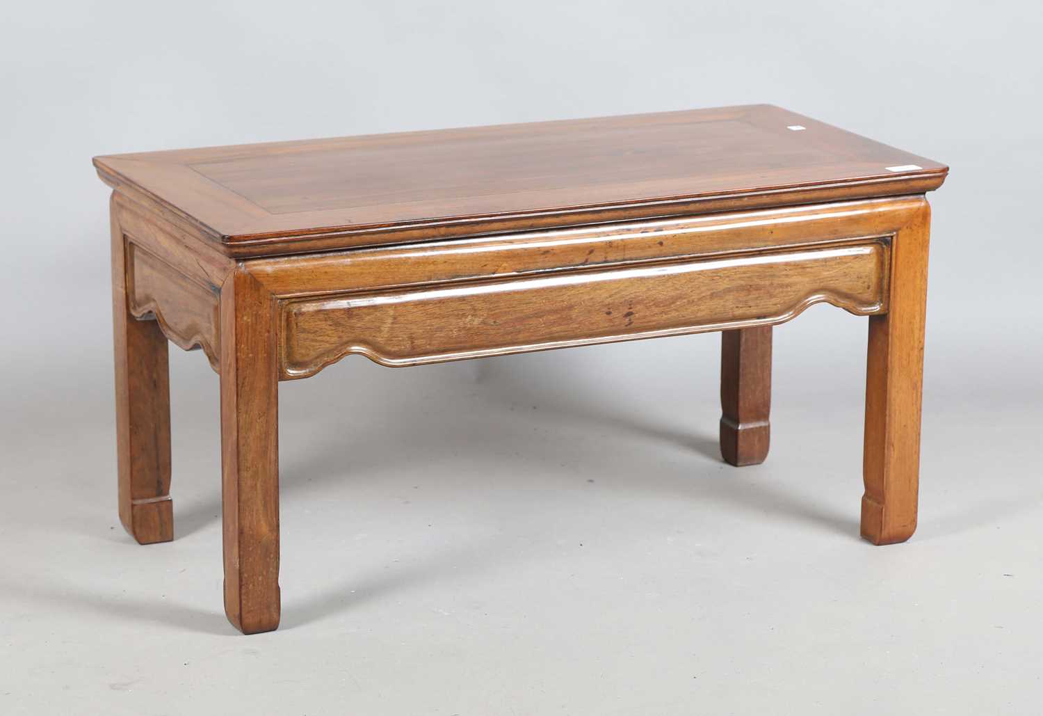 A Chinese rosewood low rectangular table with a shaped frieze and block legs, height 46cm, width