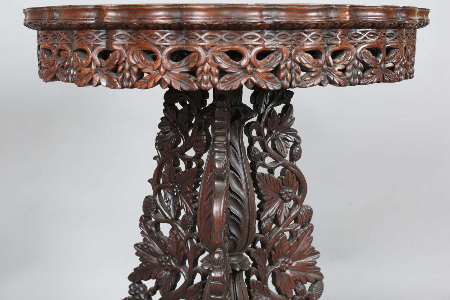 A 19th century Burmese hardwood centre table, the shaped circular top above a tripod support of - Image 4 of 13