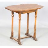 An early 20th century Arts and Crafts style oak canted rectangular occasional table, raised on