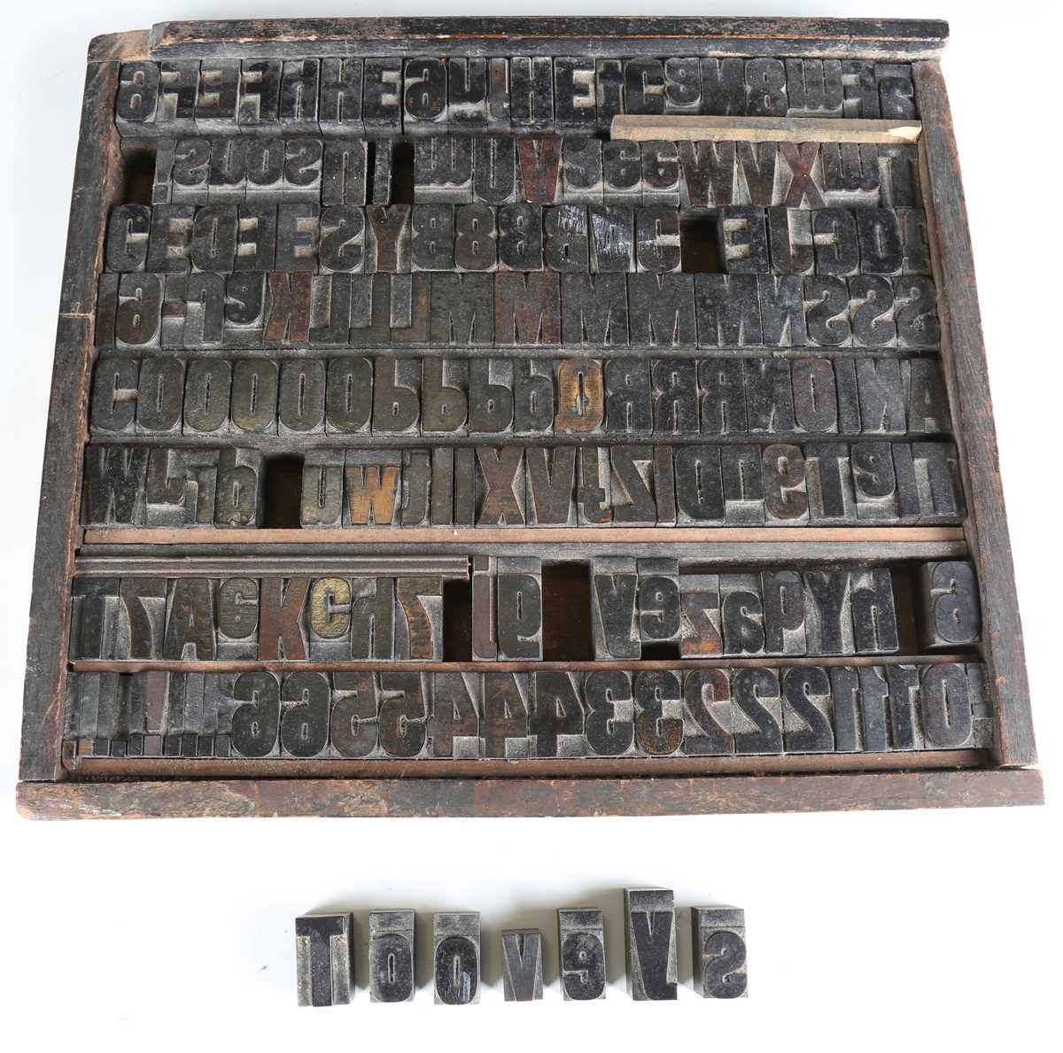 A group of early 20th century carved hardwood letterpress printing blocks, contained within a