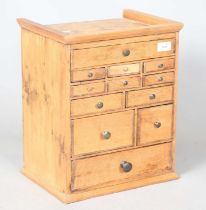 A small 19th century pine bank of twelve drawers, height 40cm, width 33cm. Provenance: from the