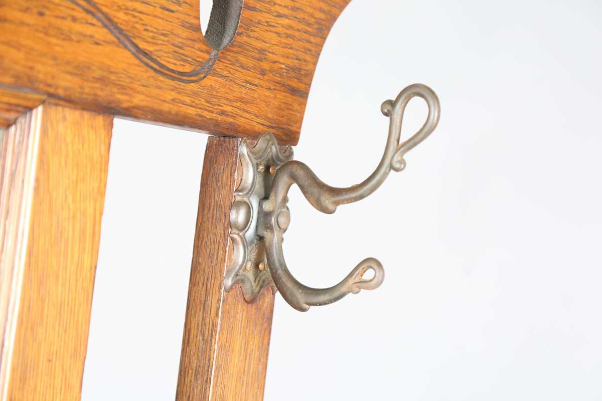 An Edwardian Arts and Crafts oak hallstand, the pediment pierced with stylized tulips, height - Image 2 of 15