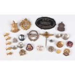 A group of badges, buttons and insignia, including an oval cloth badge, detailed ‘Cambridge