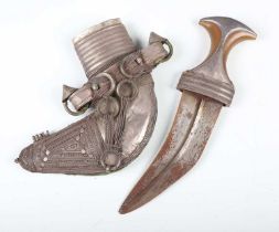 An early to mid-20th century Middle Eastern jambiya with typical curved ribbed double-edged blade,