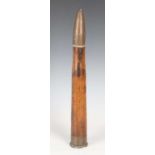 A Second World War period brass-mounted wooden practice shell (deep crack to length of wood