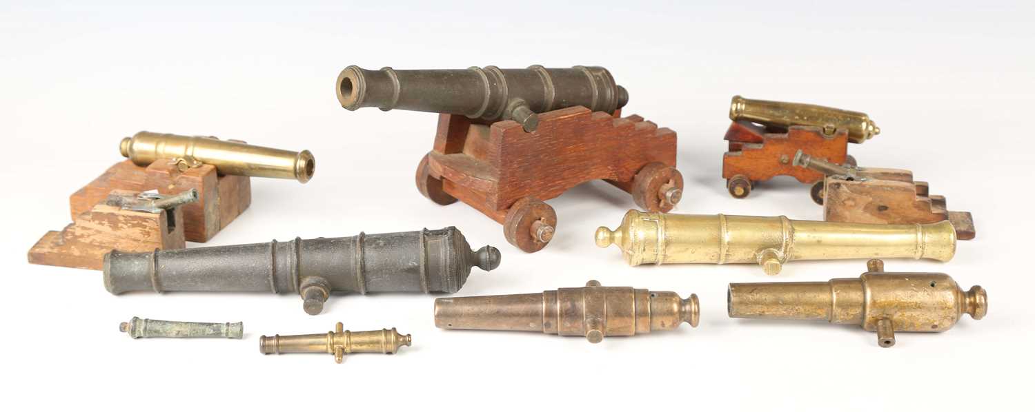 A collection of 19th and early 20th century signal, model and toy cannons, including a pair of