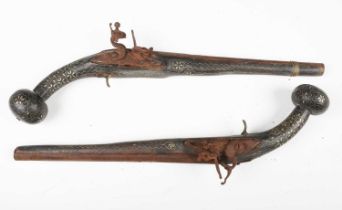 A pair of 18th century and later Middle Eastern flintlock pistols with linear-sighted round barrels,