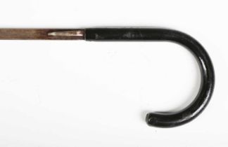 A late Victorian black-painted metal swordstick with curved handle, the steel blade with engraved