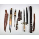 A small group of knives and edged weapons, including a mid-20th century hunting knife with etched