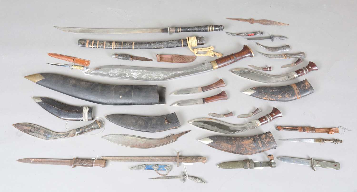 A collection of edged weapons, including a Bundeswehr MI211 military combat knife with single-