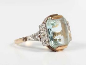 A gold, aquamarine and diamond ring, mounted with the cut cornered rectangular aquamarine between