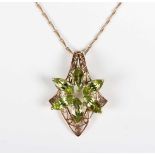 A 9ct gold and peridot pendant, claw set with six marquise shaped peridots in a flowerhead shaped