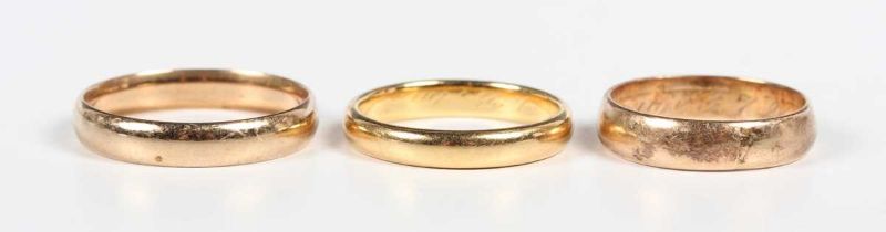A gold wedding ring, traces of inscription within the shank, unmarked, weight 5.1g, ring size approx