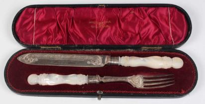 An Edwardian silver and mother-of-pearl handled bread knife and fork, each handle carved with