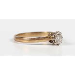 A gold, platinum and diamond single stone ring, claw set with a circular cut diamond, detailed ‘18ct