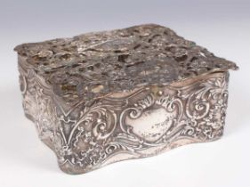 An Edwardian silver potpourri box, the cast and pierced hinged lid decorated with a shepherdess