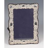 An Elizabeth II silver mounted rectangular photograph frame with floral and scroll embossed