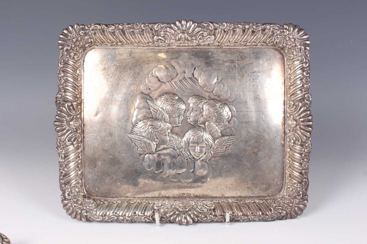 An Edwardian silver rectangular dressing table tray, embossed with amorini within a reeded and - Image 2 of 3