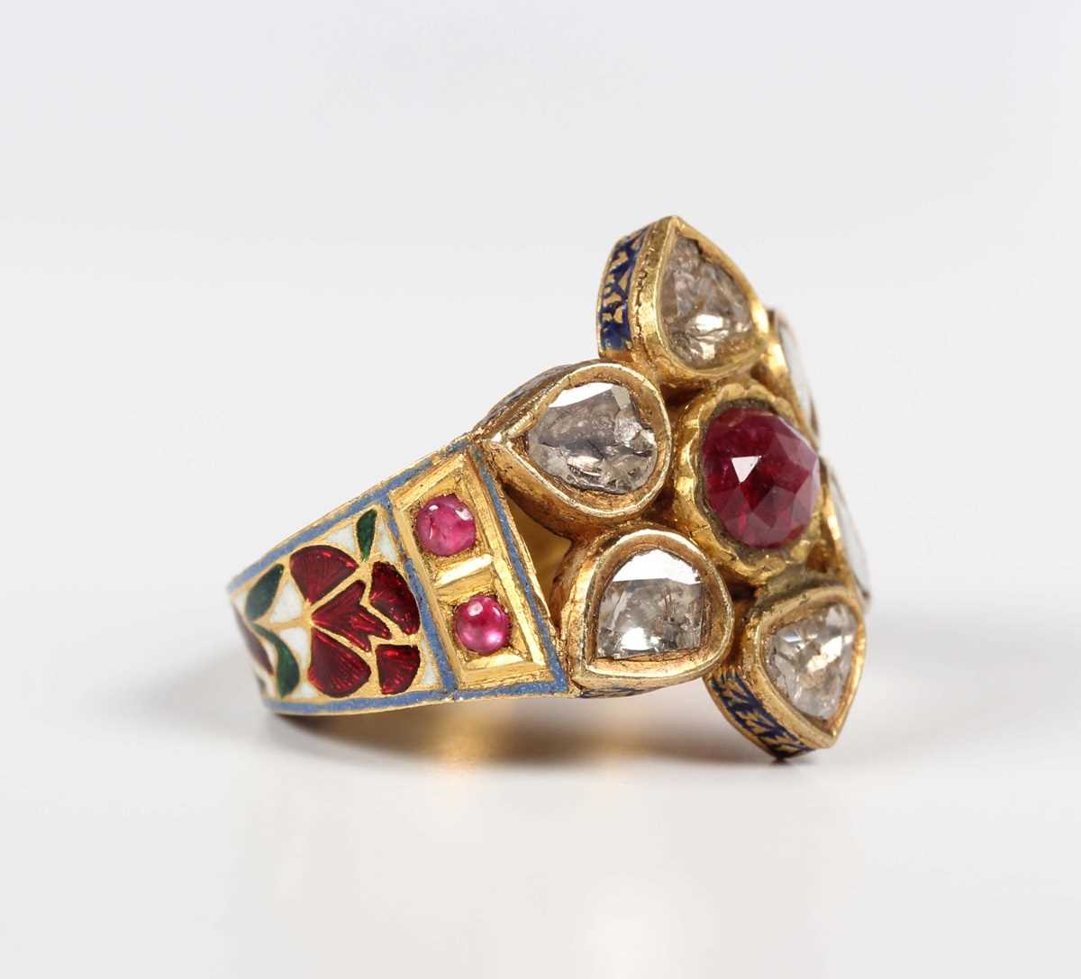 A Middle Eastern gold, ruby, diamond and varicoloured enamelled ring, probably Indian, designed as a