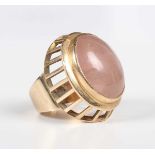 A gold ring, collet set with a large oval cabochon rose quartz, detailed ‘585’, weight 17.9g, ring