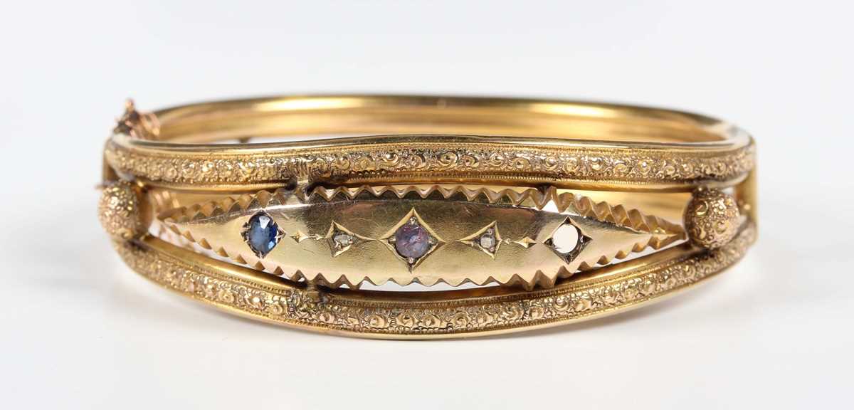 An Edwardian 9ct gold, diamond, blue gem and mauve paste set oval hinged bangle, decorated with - Image 2 of 5