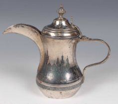 A Middle Eastern silver and niello work coffee pot, the waisted body and hinged lid decorated with a