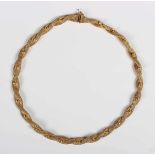 A gold braided mesh link necklace with beaded decoration at intervals, on a snap clasp, detailed ‘