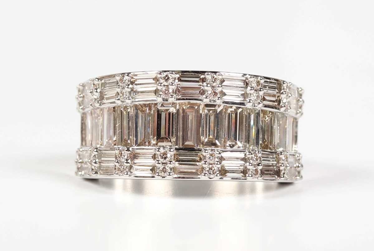 A platinum and diamond ring, mounted with a row of graduated baguette cut diamonds between rows of - Image 2 of 5