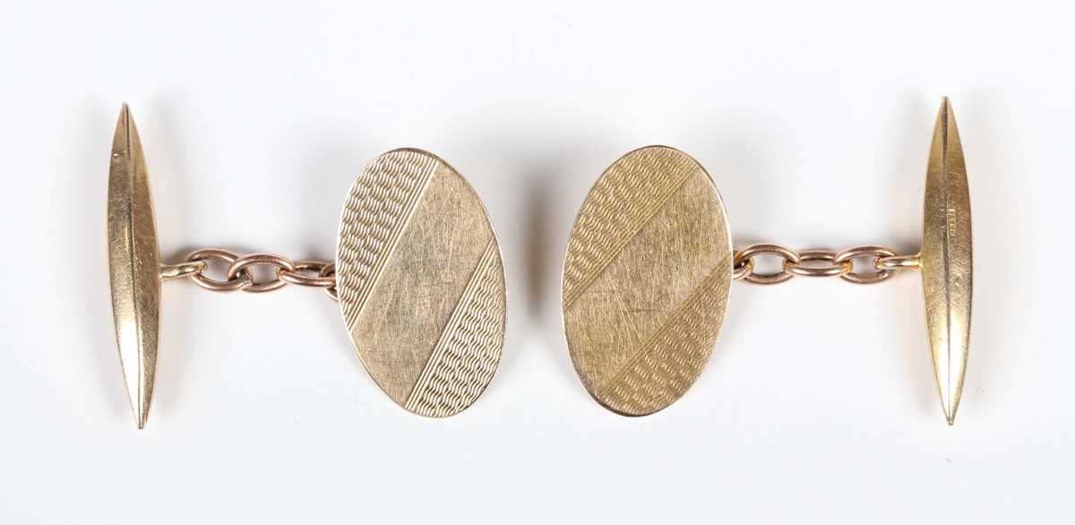 A pair of 9ct gold cufflinks, each oval front with engine turned decoration, Birmingham 1963, weight