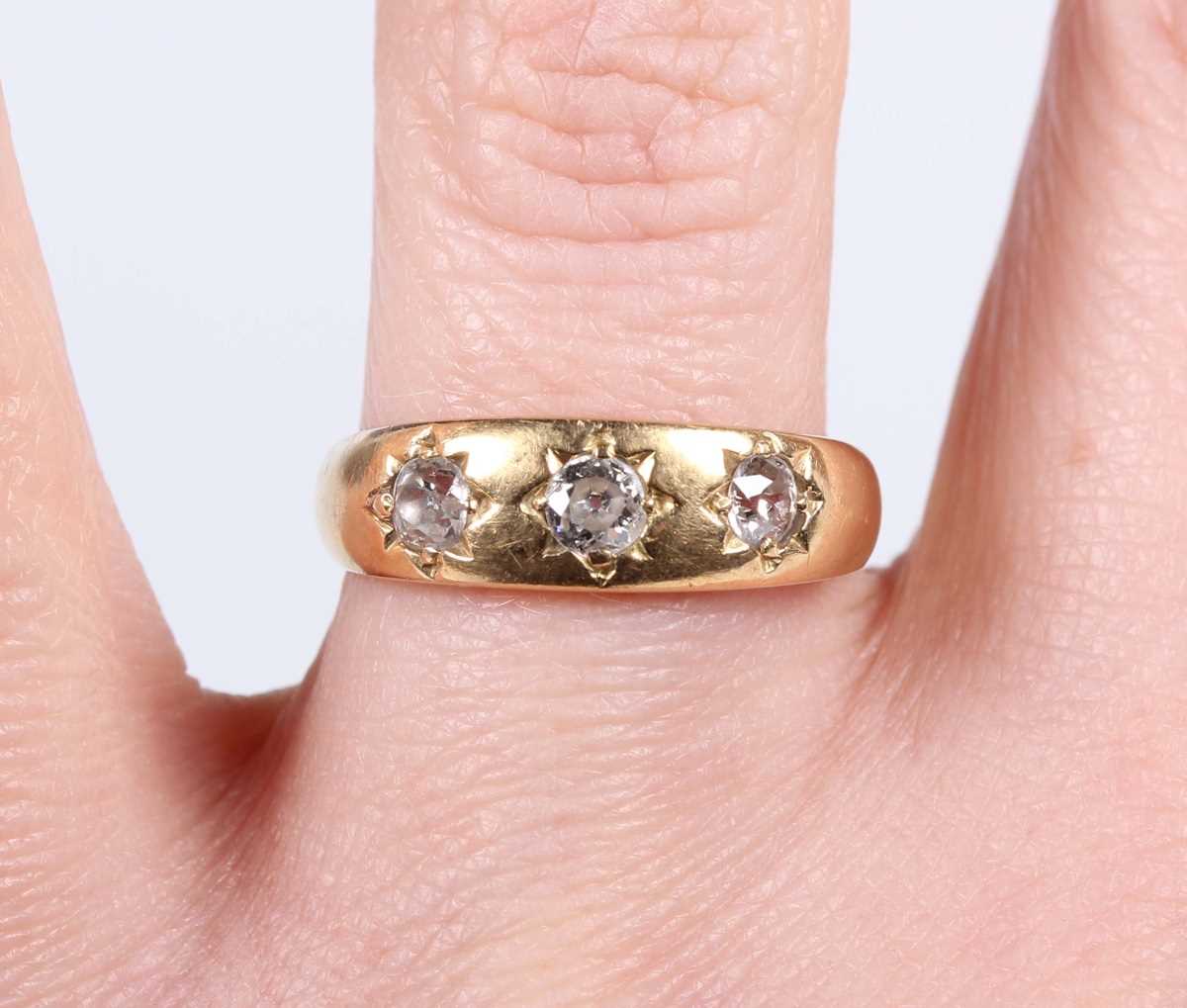 A gold and diamond three stone gypsy ring, mounted with old cut diamonds, detailed ‘18ct’, weight - Image 5 of 5