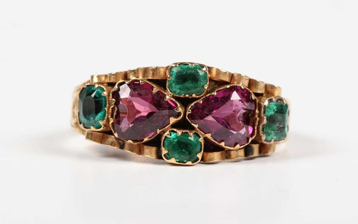 A 12ct gold, garnet, emerald and green gem set ring, mounted with two heart shaped garnets to the - Image 2 of 9