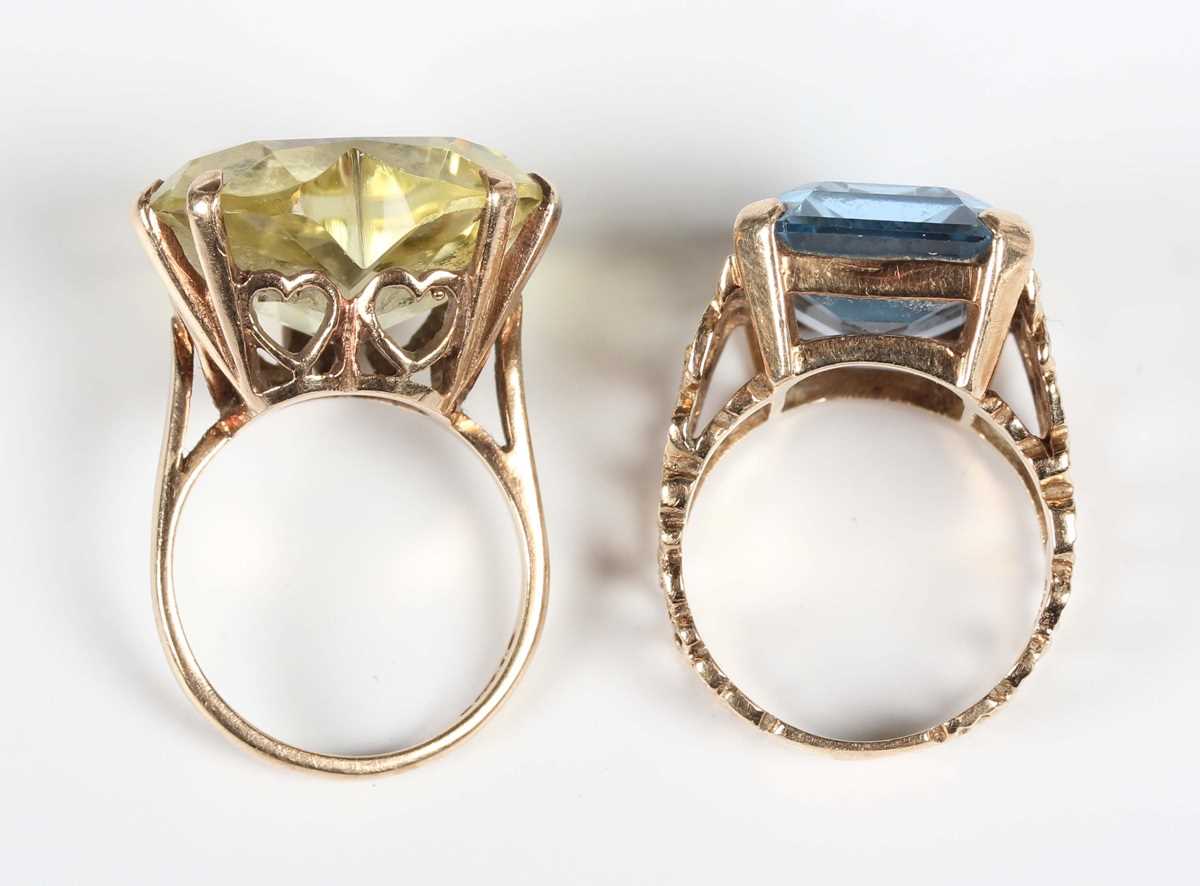 A gold ring, claw set with a cut cornered rectangular step cut synthetic blue spinel between pierced - Image 4 of 4