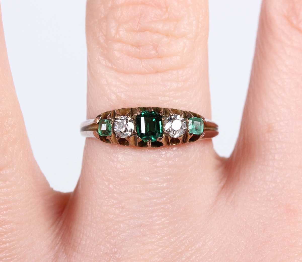A gold, diamond and green gem set ring, mounted with two old cut diamonds between three green - Image 5 of 5