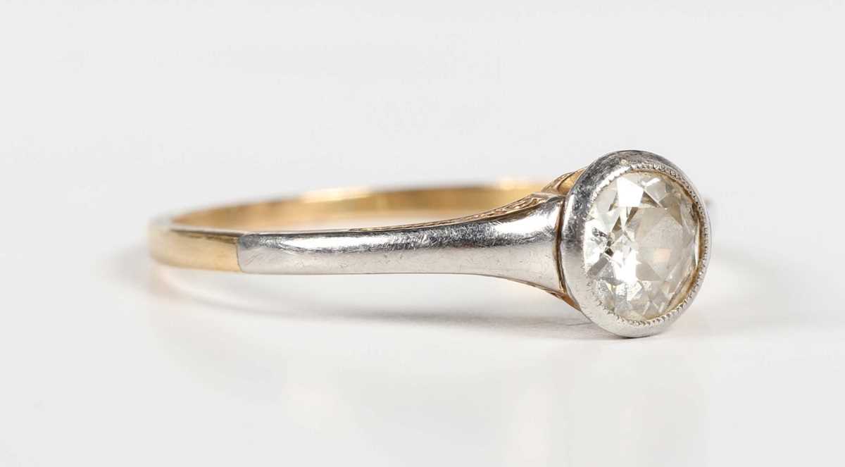 A gold, platinum and diamond single stone ring, collet set with a cushion cut diamond, unmarked,