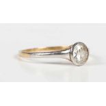 A gold, platinum and diamond single stone ring, collet set with a cushion cut diamond, unmarked,