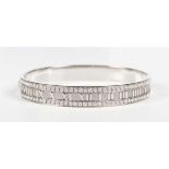 A Tiffany & Co 18ct white gold and diamond Atlas oval hinged bangle, detailed ‘Tiffany & Co 1995 750