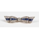 A gold backed and platinum fronted, sapphire and diamond brooch designed as a tied bow, collet set