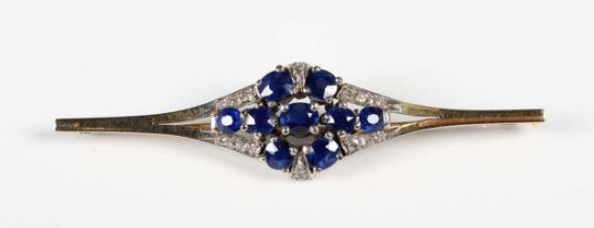 A gold, sapphire and diamond brooch, claw set with nine oval cut sapphires, otherwise mounted with