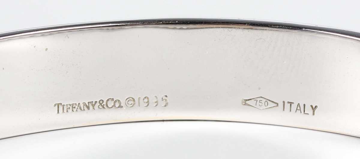 A Tiffany & Co 18ct white gold and diamond Atlas oval hinged bangle, detailed ‘Tiffany & Co 1995 750 - Image 5 of 7