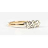 An 18ct gold and diamond three stone ring, claw set with a row of circular cut diamonds, weight 3.