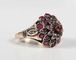 A gold, silver set and ruby harem ring, designed as a flowerhead, detailed ‘14K’, weight 8.5g,