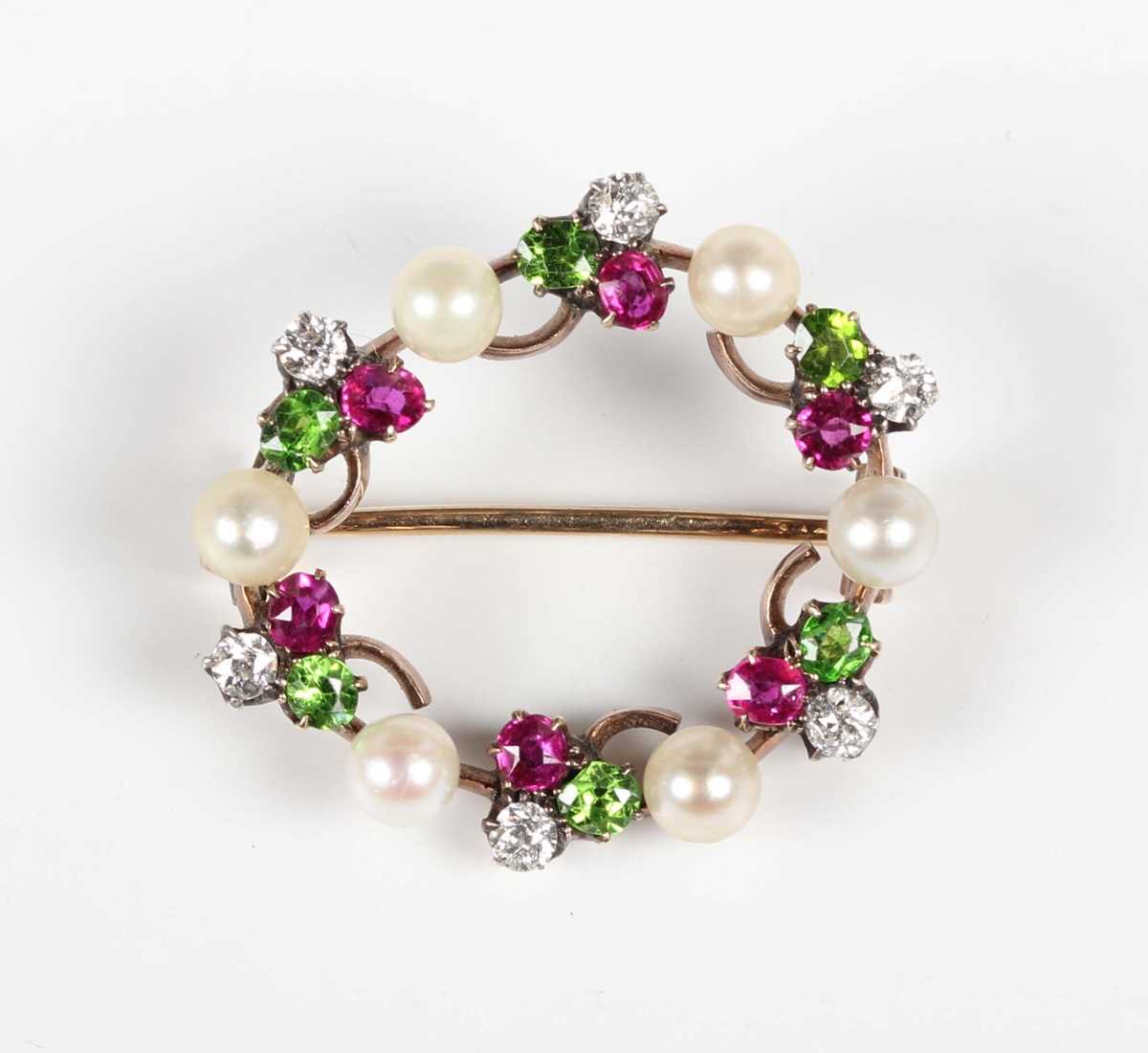 A gold backed, diamond, ruby, demantoid garnet and pearl brooch, designed as a wreath with trefoil