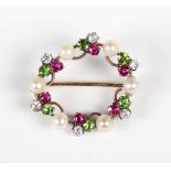 A gold backed, diamond, ruby, demantoid garnet and pearl brooch, designed as a wreath with trefoil