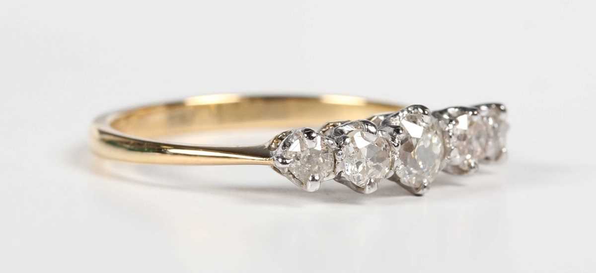 A gold and diamond five stone ring, claw set with a row of graduated old cut diamonds, detailed ‘