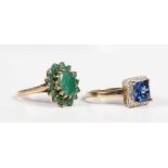 A 9ct gold and emerald oval cluster ring, the principal oval cut emerald within a surround of
